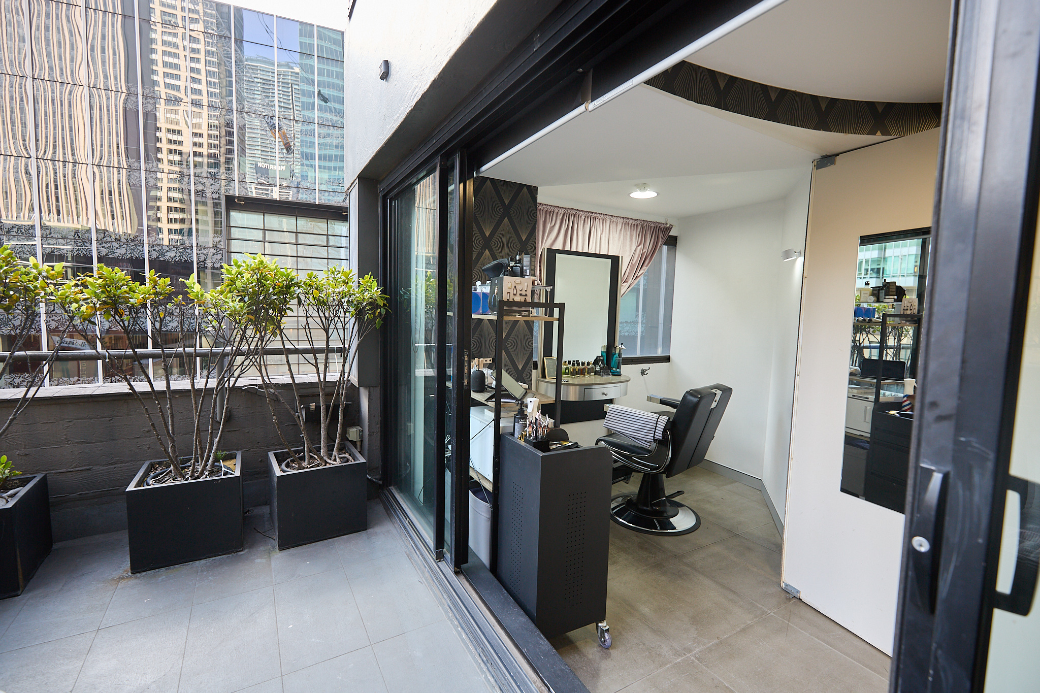 True Hair Collective boutique salon styling station with private terrace overlooking Sydney CBD